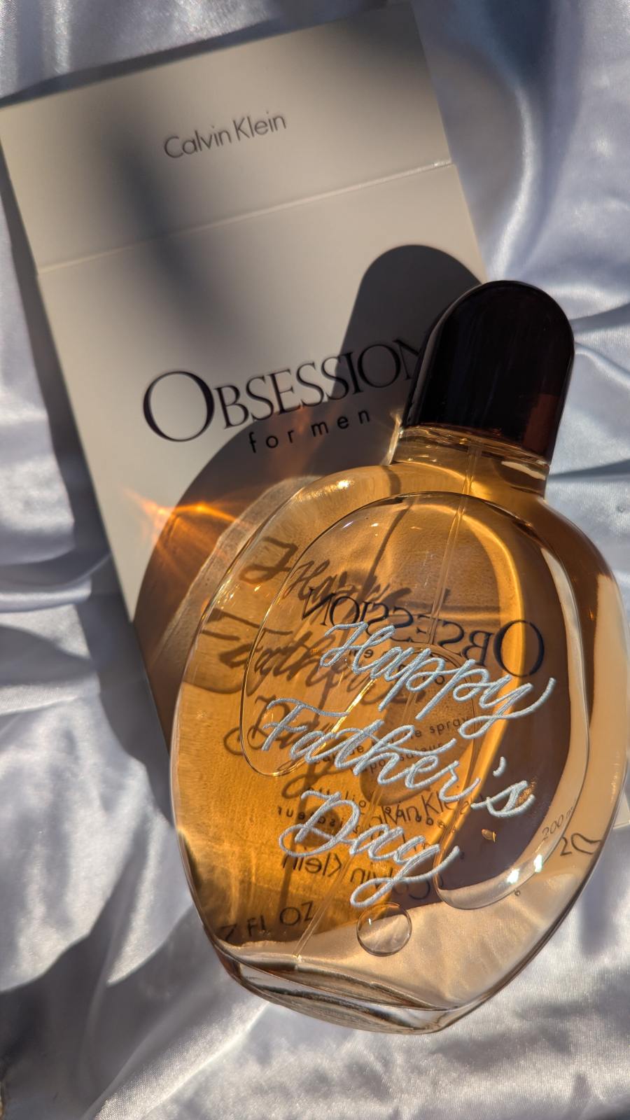Hand engraved Calvin Klein Obsession for Men cologne bottle with silver fill, featuring the message “Happy Father’s Day.” Personalized fragrance gift perfect for Father’s Day, custom gifting, or luxury brand activations.