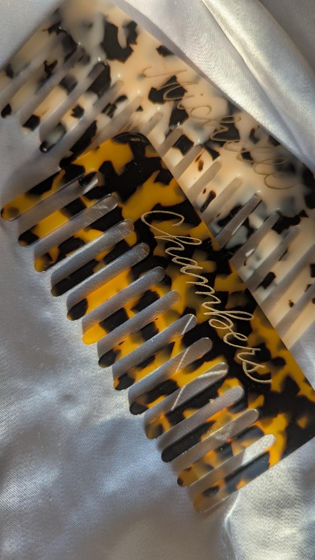 Tortoiseshell wide-tooth combs hand engraved with gold fill, featuring personalized names “Chambers” and “Michelle.” Custom engraved hair accessories perfect for bridesmaid gifts, self-care sets, or luxury event activations.