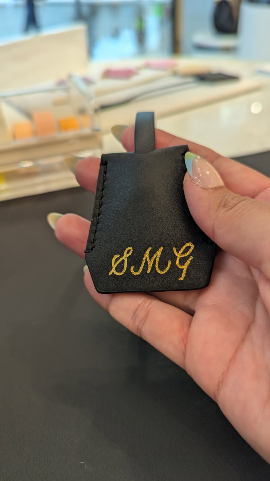 Heat foiled leather tag personalized at luxury brand activation for Versace at King of Prussia Mall in Philadelphia, Pennsylvania.