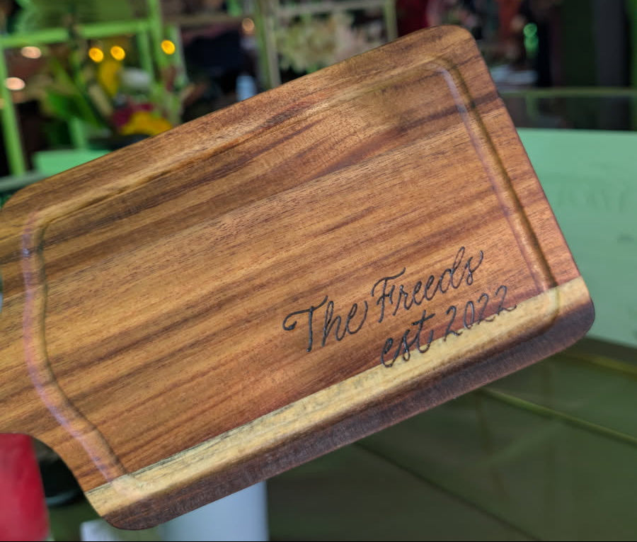 Hand wood-burned charcuterie board reading “The Freeds Est. 2022,” created for a 50th birthday celebration for the CEO of C and J Catering at Historic Acres of Hershey wedding and event venue in Hershey, Pennsylvania.
