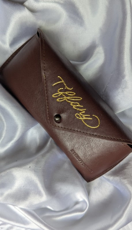 Hand heat foiled leather eyeglasses case with gold foil personalization reading “Tiffany.” Elegant and custom eyewear accessory perfect for gifting, brand activations, or luxury event keepsakes.