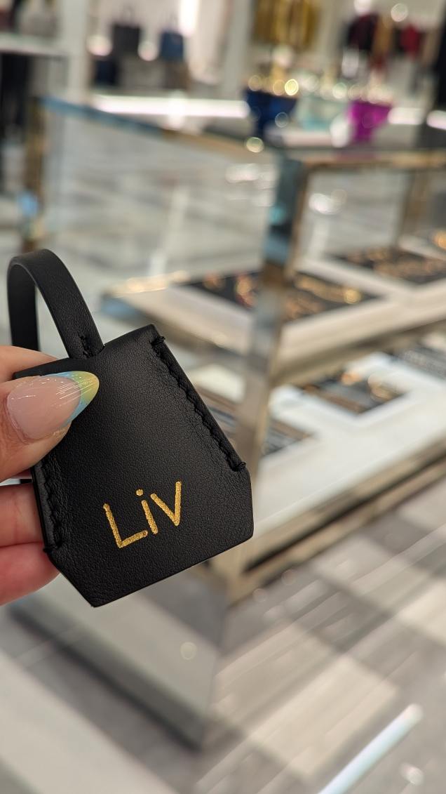 Heat foiled leather tag personalized at luxury brand activation for Versace at King of Prussia Mall in Philadelphia, Pennsylvania.