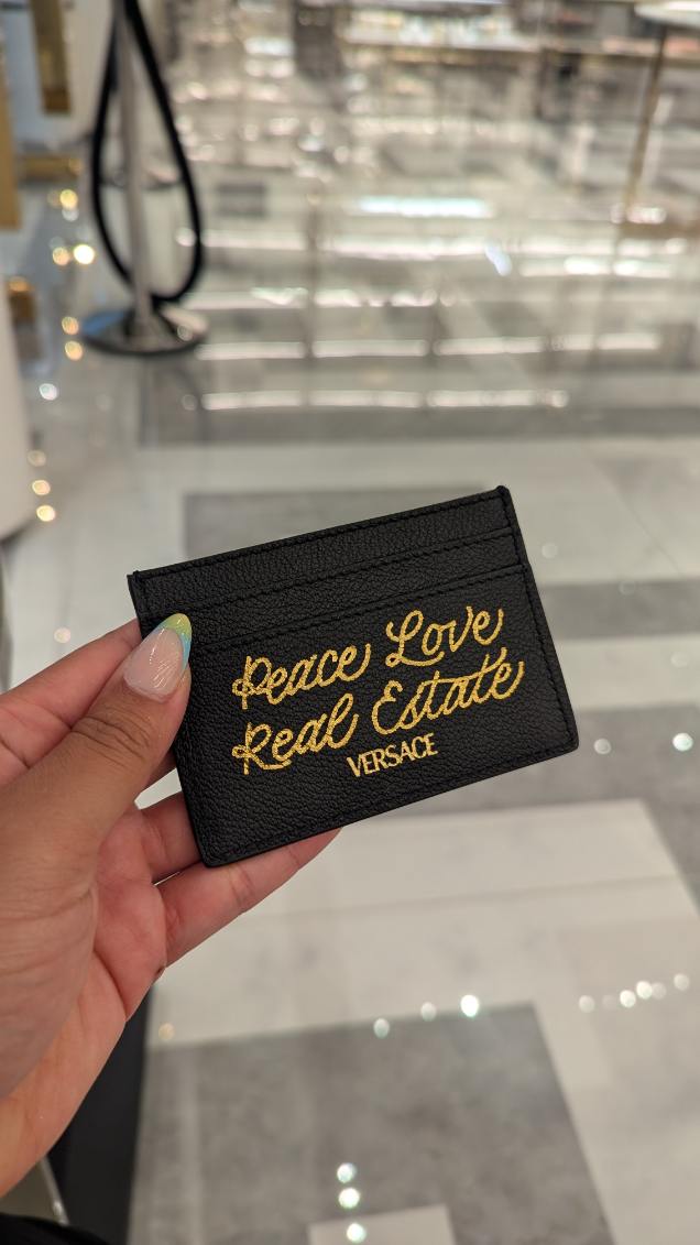 Heat foiled Versace black leather wallet customized during luxury brand activation at Versace, King of Prussia Mall in Philadelphia, Pennsylvania.