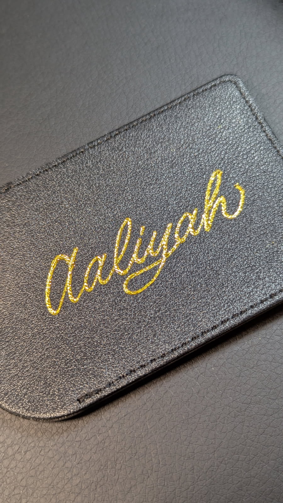 Black leather luggage tag with elegant gold heat foil calligraphy personalization, custom luxury gift by professional calligrapher SLM & Design Co.
