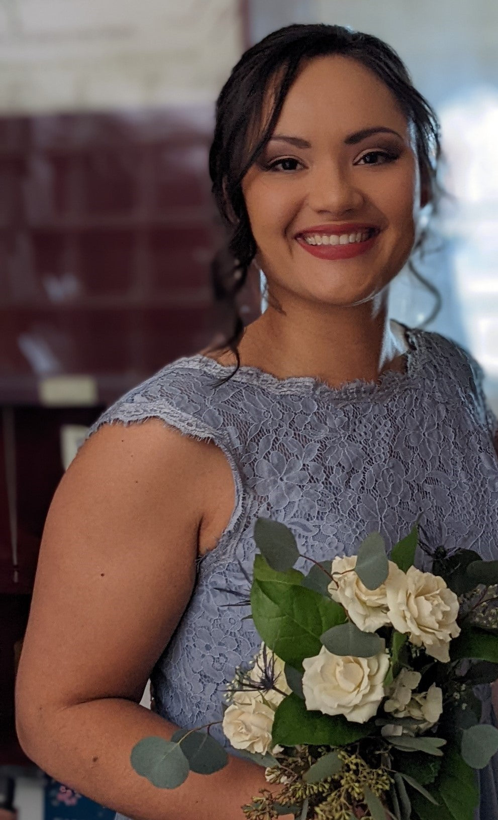 Maid of honor in dusty blue lace dress with white rose bouquet at St. Joan of Arc Catholic wedding in Hershey, Pennsylvania