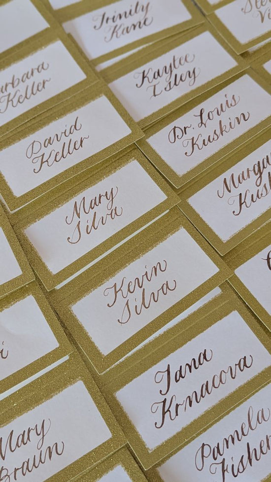Elegant gold calligraphy place cards with shimmer borders for school fundraiser event at Letort View Conference Center in Carlisle, Pennsylvania.
