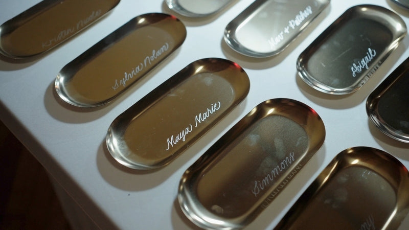 Close-up of hand engraved gold jewelry trays at the Faire Sol Women Empowered event in Lancaster, PA.