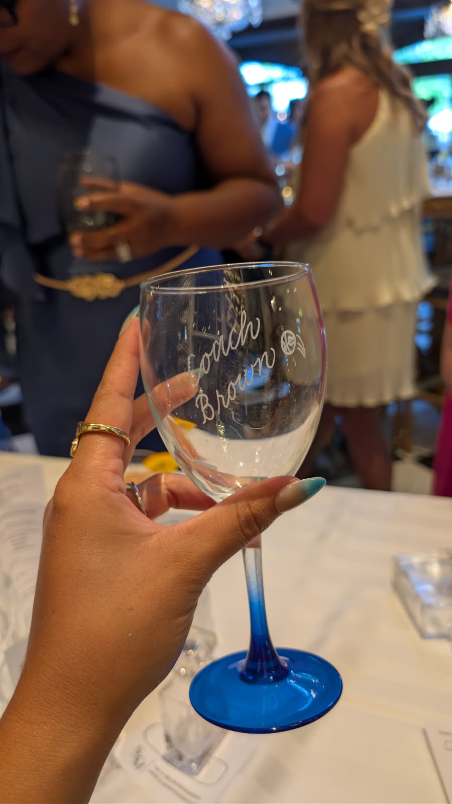 Hand engraved wine glass featuring the name "Coach Brown" and a basketball design, created at a wedding reception at The Willows at Ashcombe in Mechanicsburg, PA. Custom live engraving by SLM & Design Co. celebrating a personalized sports-themed keepsake.