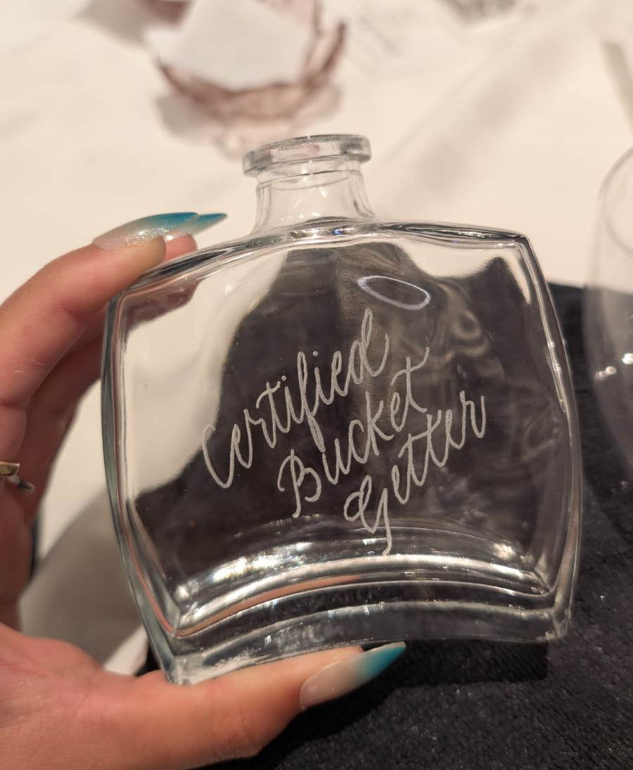 Live engraved bud vase featuring the phrase "Certified Bucket Getter" for a Love & Basketball-themed wedding reception at The Willows at Ashcombe in Mechanicsburg, PA. Custom wedding guest favor engraved on-site by SLM & Design Co.